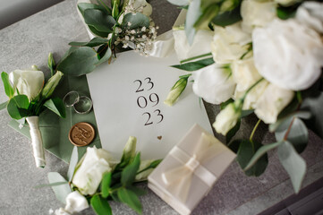 Wedding day. Bouquets and various wedding accessories, shoes, invitations, rings in the morning at the bride's preparation