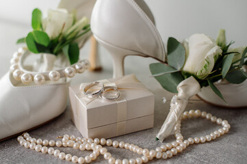 Wedding day. Bouquets and various wedding accessories, shoes, invitations, rings in the morning at the bride's preparation