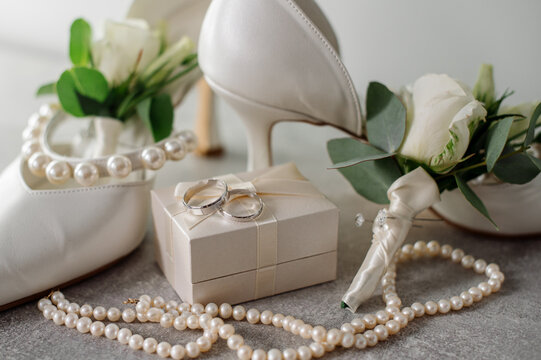 Wedding day. Bouquets and various wedding accessories, shoes, invitations, rings in the morning at the bride's preparation