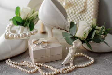 Wedding day. Bouquets and various wedding accessories, shoes, invitations, rings in the morning at the bride's preparation