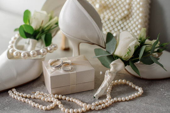 Wedding day. Bouquets and various wedding accessories, shoes, invitations, rings in the morning at the bride's preparation