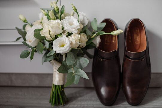 Wedding day. Bouquets and various wedding accessories, shoes, invitations, rings in the morning at the bride's preparation