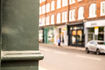 Defocussed high street shops with blank space on left of image
