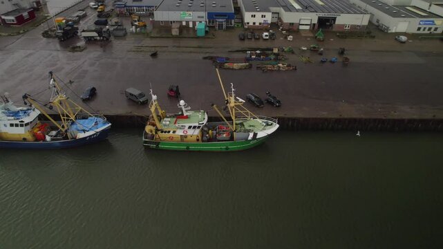 Aerial Shot of Fishing Ship Resting at a Dutch Harbor Dock Under Gloomy weather
