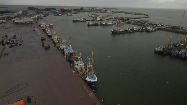 Under a Cloudy Sky: Aerial View of Dutch Harbor Fishing Ships Resting in the Stillness