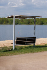 Benches for relaxing on the embankment near the lake, public places