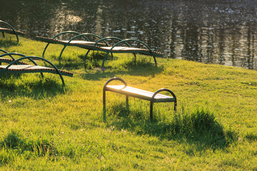 Wooden benches and chaise lounges for rest on the streets of the city and in the park, public places