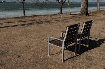 Benches for relaxing on the embankment near the lake, public places