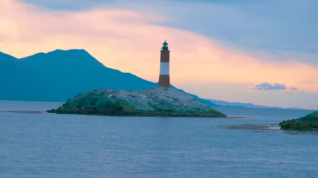 Les Eclaireurs Lighthouse stands on a rocky islet in the Beagle Channel near Ushuaia, Argentina, at sunset. Aerial drone view.