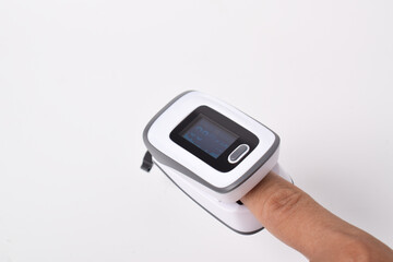 Pulse oximeter with hand of patient isolated on white background. Pulse Oximeter portable digital device to measure person's oxygen saturation.
