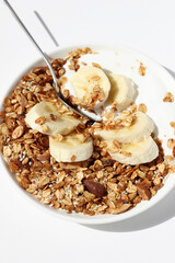 Greek Yogurt with Granola and Banana. Traditional Breakfast Food.