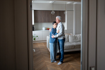 Tired sad mature husband and wife in grief embracing hugging, man comforts wife, holding close....