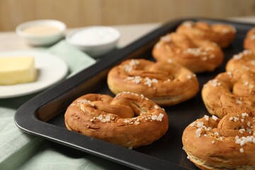 Tasty pretzels and ingredients on table, closeup