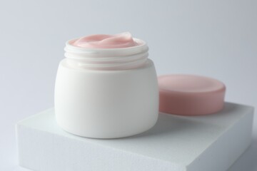Jar of moisturizing body cream on white background, closeup