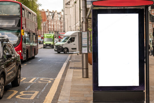 A blank bus stop advertising board on busy London street with space for copy, text or generative fill