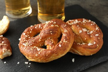Tasty pretzels on dark textured table, closeup