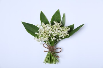 Beautiful lily-of-the-valley flowers on white background, top view