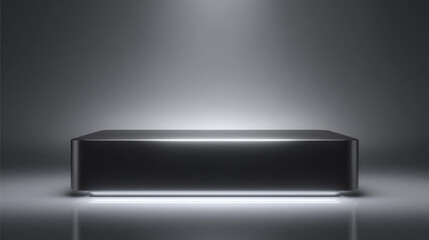 A sleek, modern black box illuminated by soft lighting in a minimalist setting.