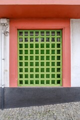 Vibrant Green Lattice Window with Colorful Frame, Terceira. Eye-catching close-up of a bright green...
