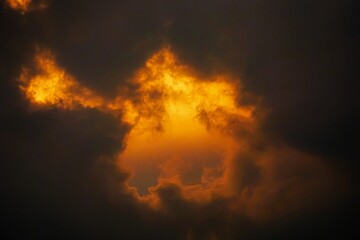 Dramatic clouds at sunset with vibrant orange hues.
