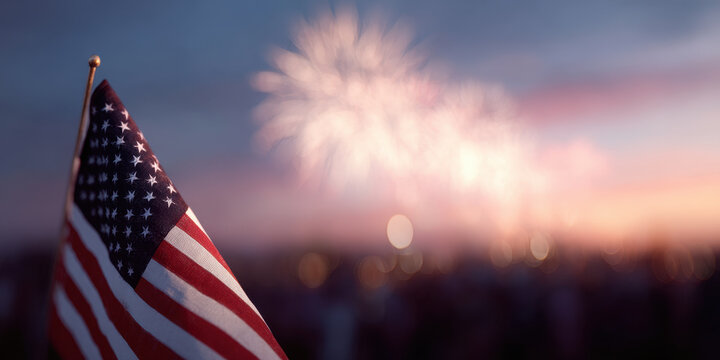 American flag with fireworks in background at sunset