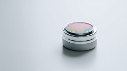 Elegant cosmetic container with colorful powders on a minimalistic background.