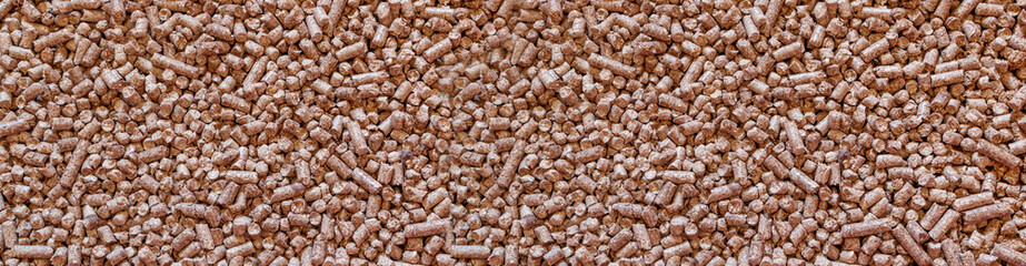Wood cat litter textured background. Compressed sawdust pellets pattern top view