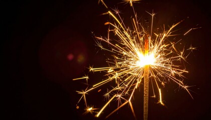 burning sparkler casting light on a dark background
