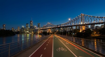 Fototapeta premium City Skyline at Dusk Over River and Bridge with Cycling Path