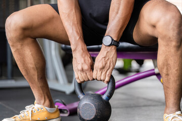 Fitness Training with Kettlebell. Athlete preparing for workout in gym.