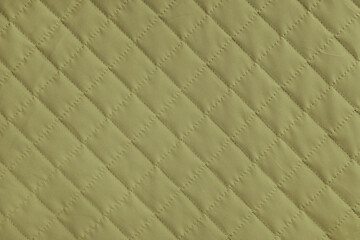 Obraz premium Checkered, diamond stitching pattern, khaki quilted fabric background. Blanket or puffer jacket, stitch rhombus texture close up, macro. Wallpaper, backdrop.