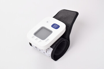 Digital wrist blood pressure monitor isolated on white background. Health care and check up concept