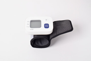 Digital wrist blood pressure monitor isolated on white background. Health care and check up concept