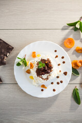 sweet cottage cheese breakfast in a plate with chocolate syrup and candied fruits