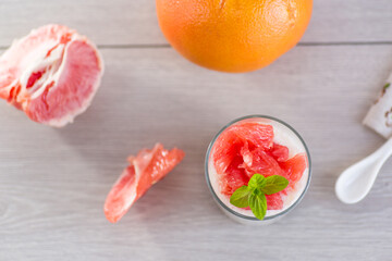 Homemade yogurt with ripe grapefruit in a glass