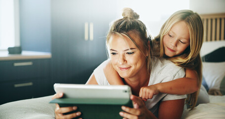 Happy mom, kid and pointing with tablet on bed for online entertainment, show or cartoon at home....