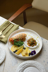 Lobster tail on restaurant table with elegant cutlery
