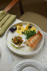Plated lobster with edible flowers and potato purée