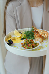 Waitress presenting gourmet lobster dish