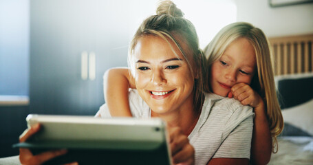 Happy mother, child and relax with tablet on bed for online entertainment, show or cartoon at home. Mom, daughter or kid lying with smile on technology for subscription, app or streaming in bedroom