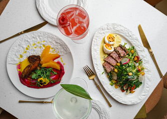 Gourmet restaurant dishes with wine and cocktails