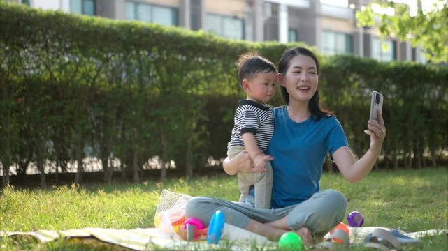 While in vacation at home, a mother engages in activities with little kid in the park