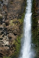 Close-up view of Hunua Falls cascading over rocky cliff