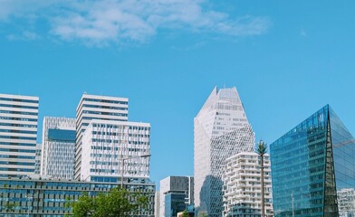A wide-angle daytime view of the Casa Finance City district in Casablanca, Morocco, showcasing a cluster of contemporary high-rise buildings with unique architectural designs under a clear blue sky