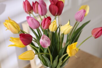 Bouquet of beautiful tulips on wooden table indoors, closeup