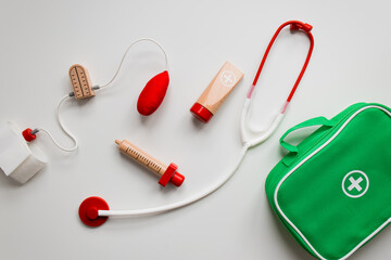 Colorful wooden toy doctor kit with stethoscope and medical accessories for children