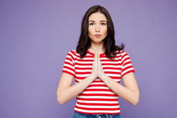 Young woman she wear red striped t-shirt casual clothes hold hands folded in prayer gesture,...