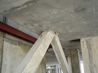 Interior perspective of concrete support structures within a building during its construction phase.