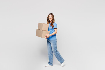 Full body young happy Caucasian woman wears blue t-shirt casual clothes hold blank cardboard box...