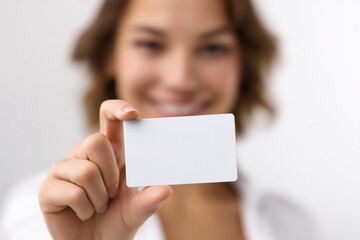 Smiling woman holding blank white card for business concept or mockup presentation